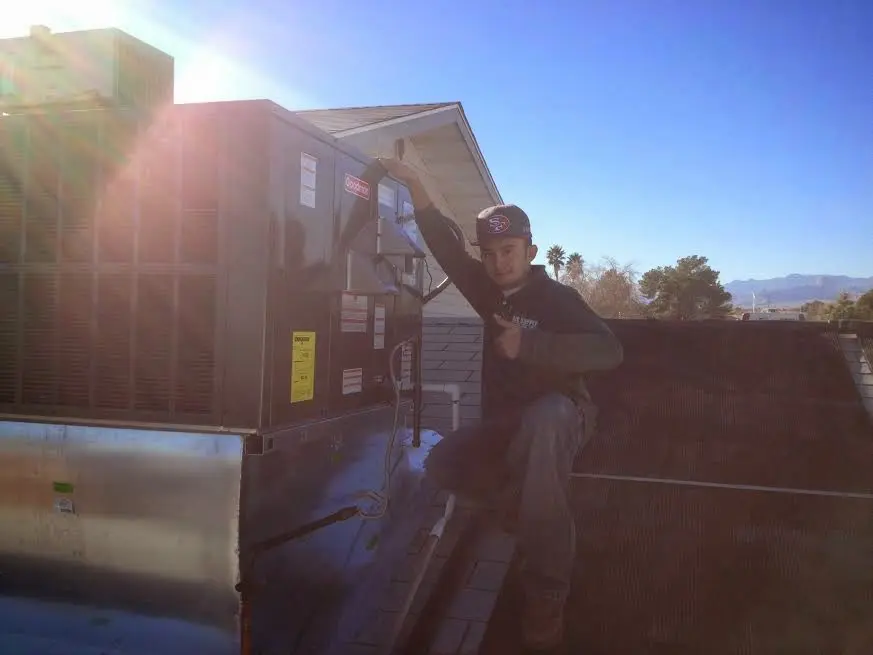 HVAC technician performing HVAC Inspection on a rooftop unit in Glen Allen